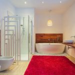 Washing bathroom rugs with towel.