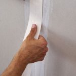 Applying tape on drywall seams.