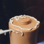 Applying silicone sealant to plastic.