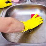 Polishing stainless steel sink.