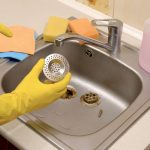 Cleaning kitchen sink strainer.