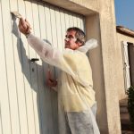 Painting metal garage door.